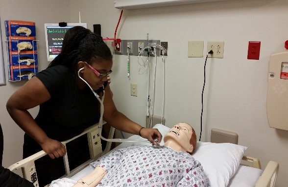 LPP student working on a health care dummy.