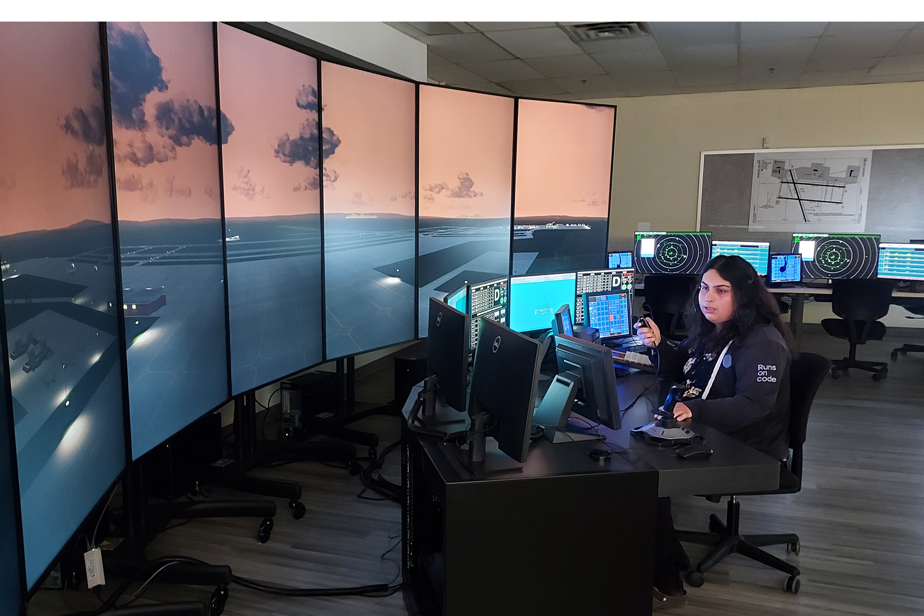 Student sitting at Air Traffic Control simulator