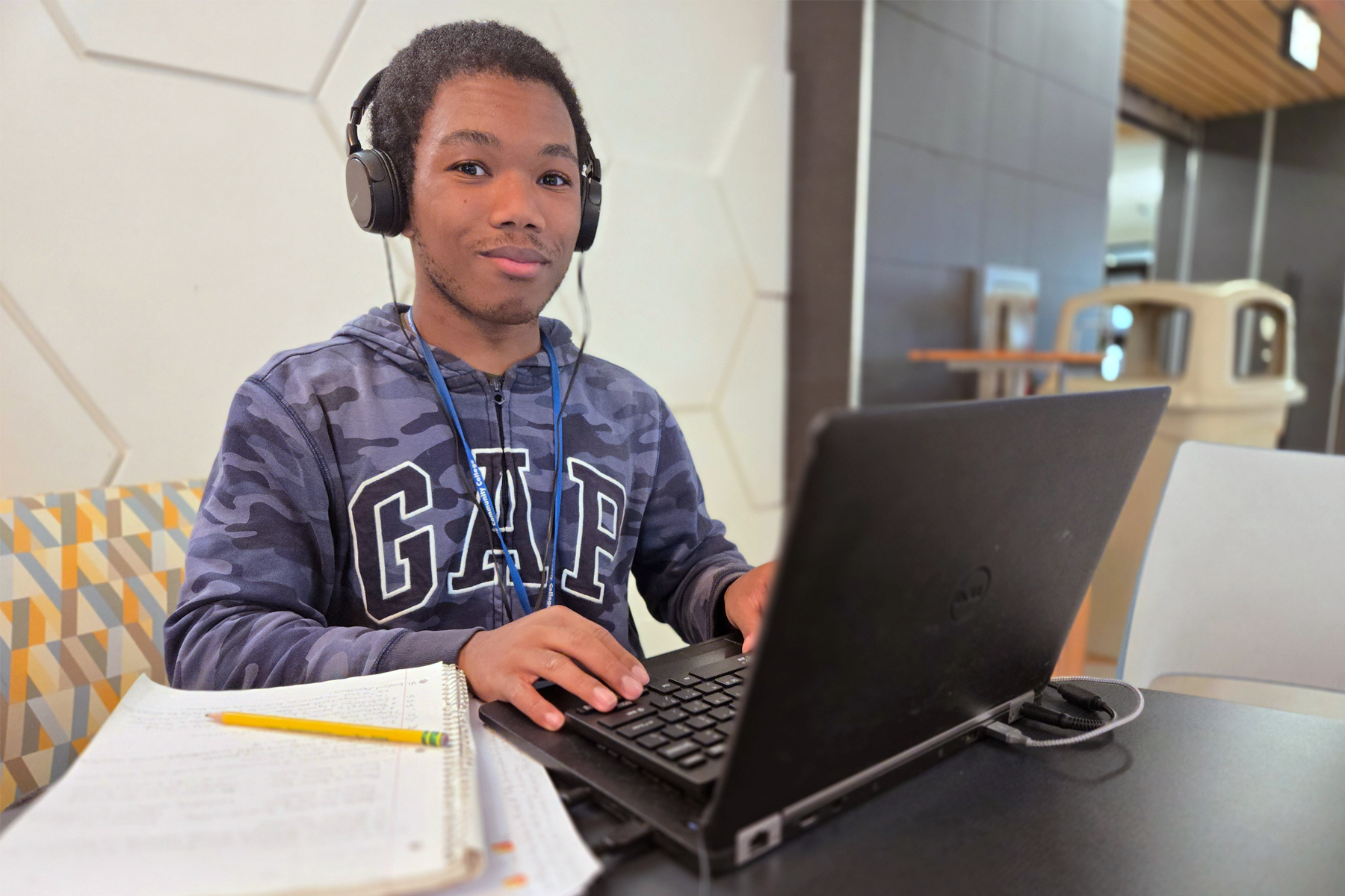 Dominick Powell sitting at table with laptop