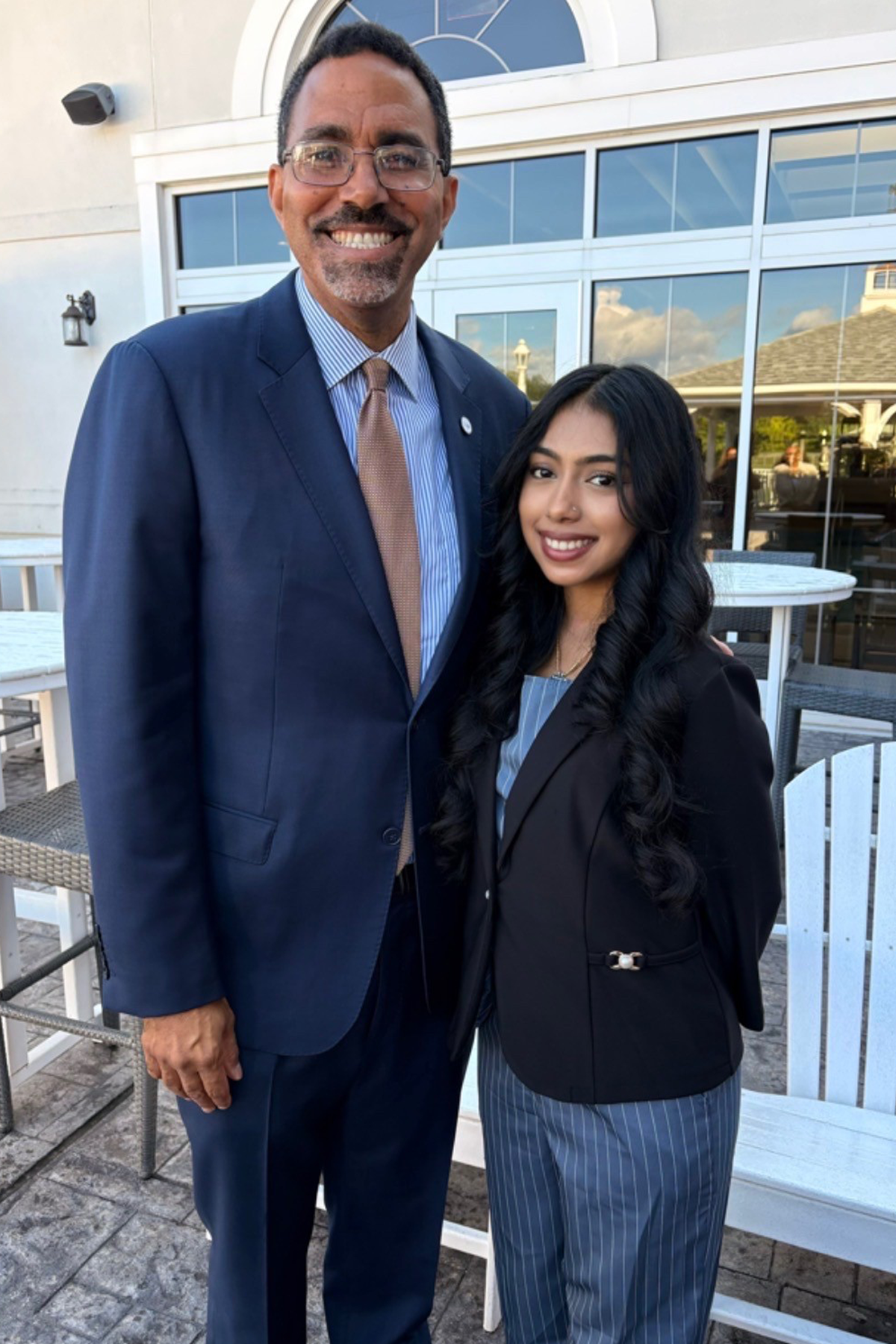 SUNY Chancellor John B. King Jr. standing outside next to Hema Singh, Student Trustee