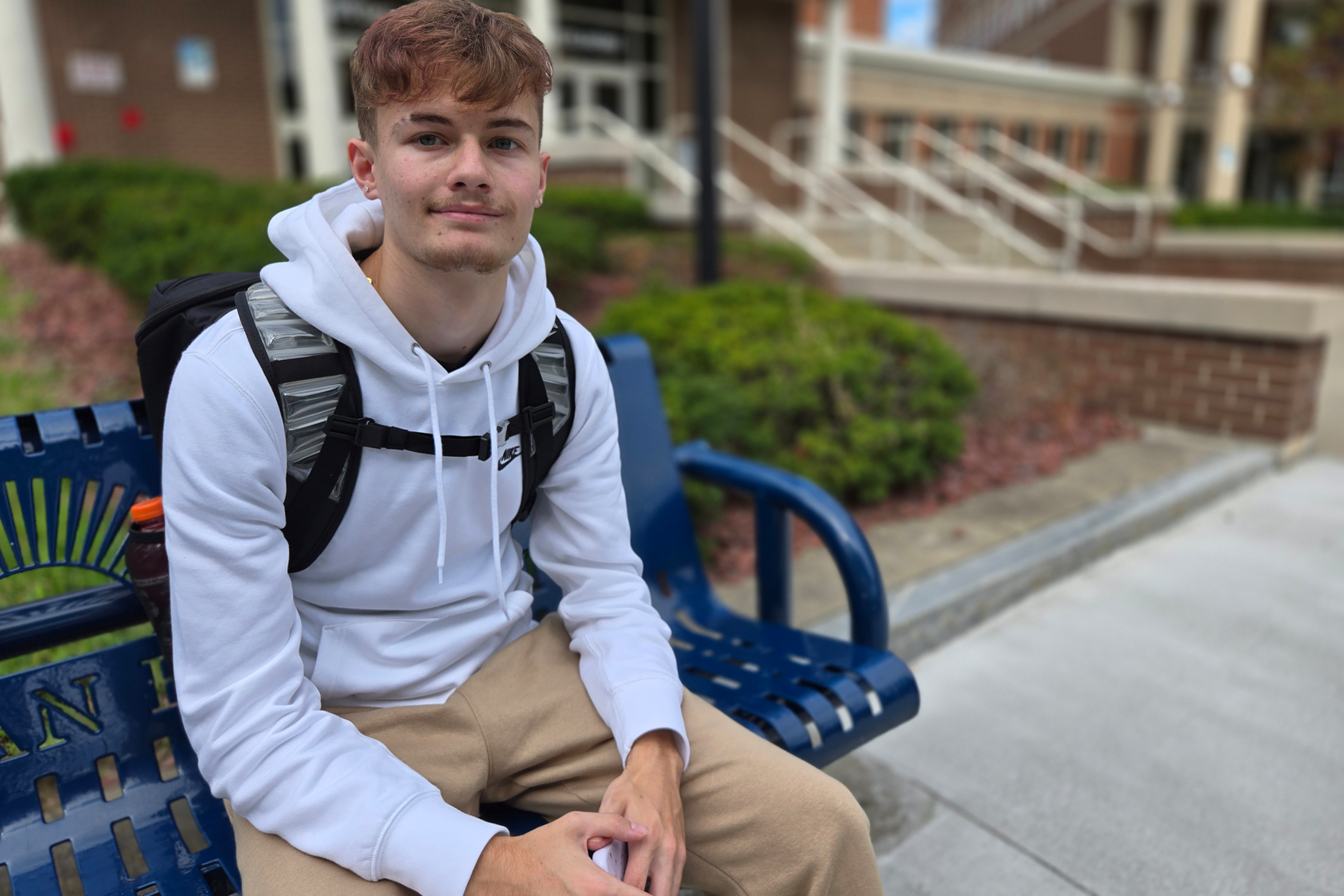 Shane Hayden sitting outside on bench in The Quad