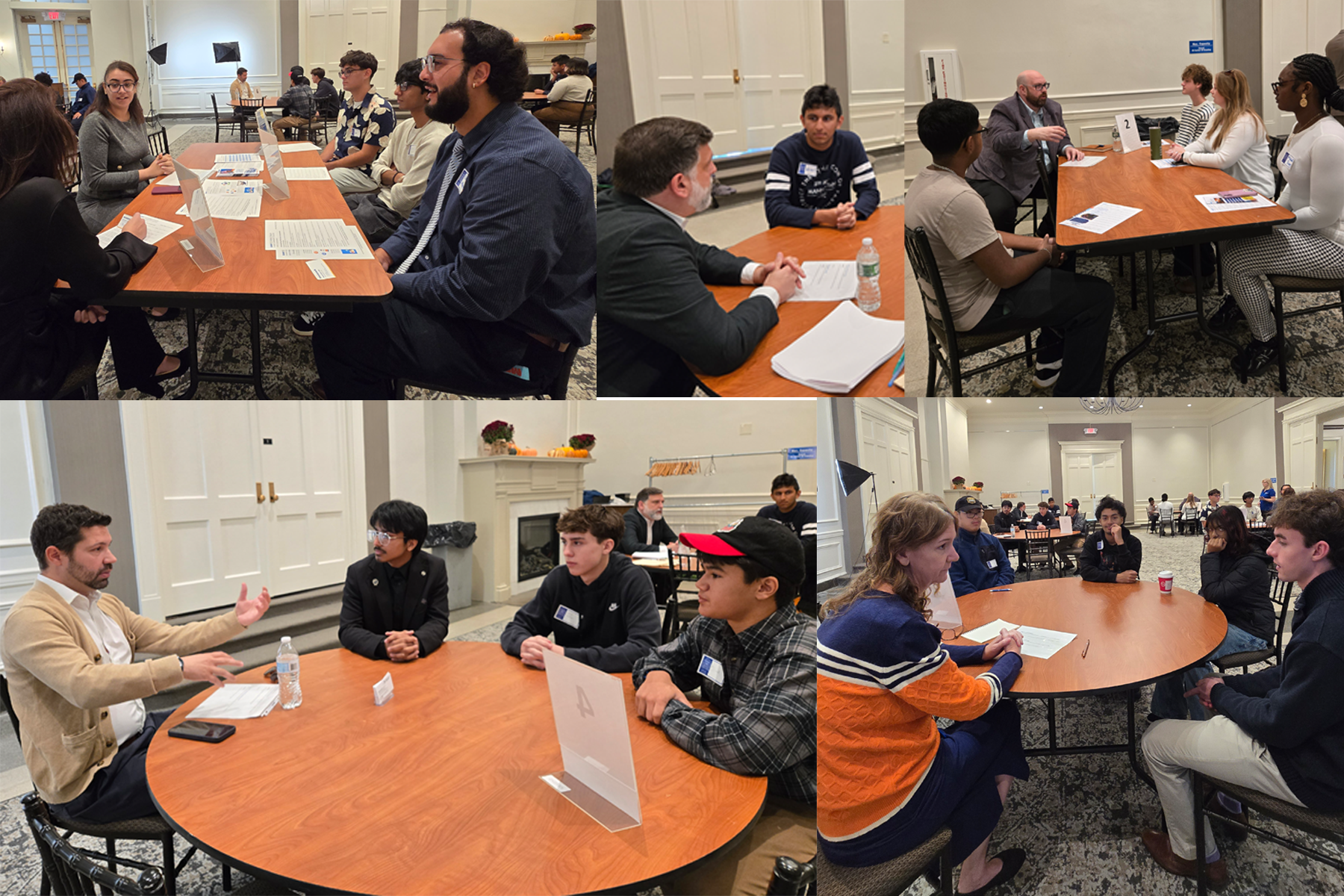 Students and mentors sitting at tables speaking with one another