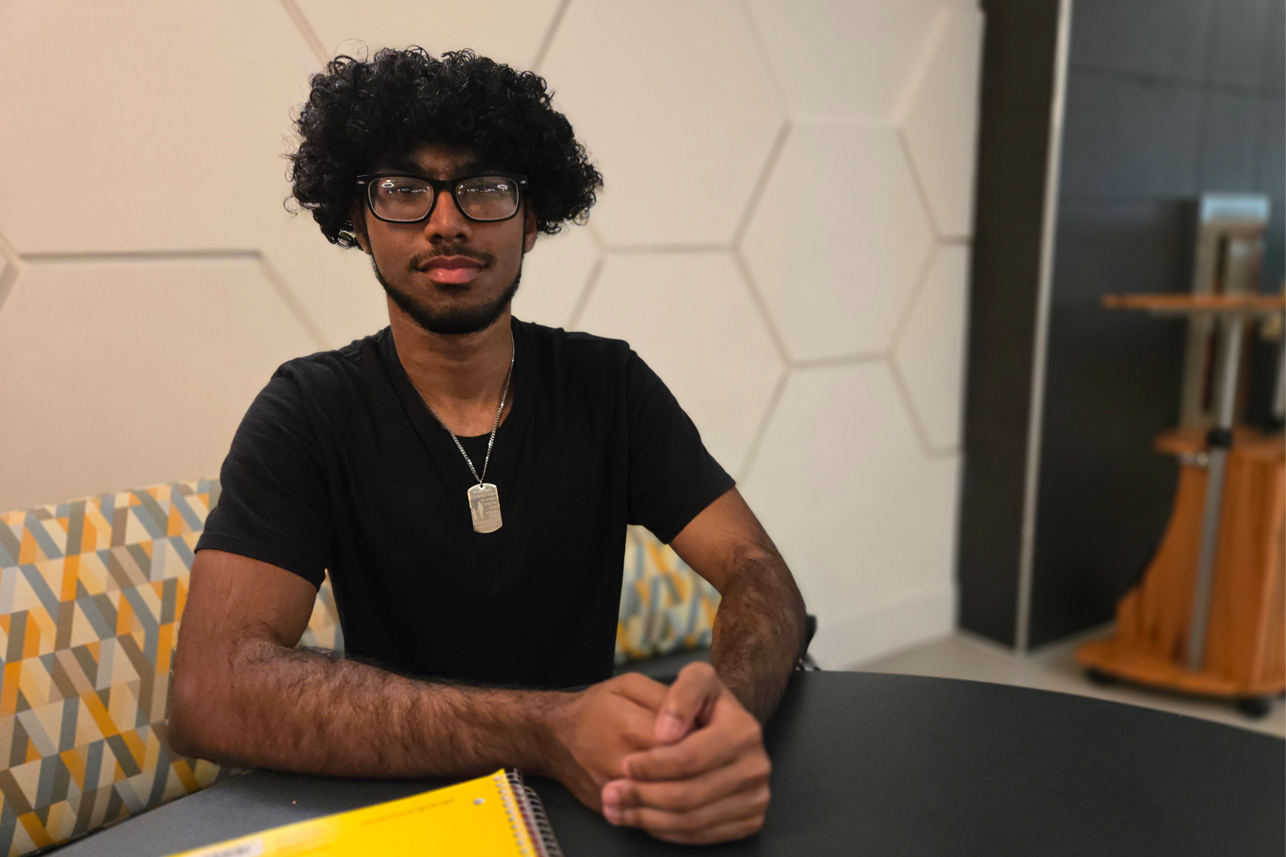 Victor Cabrera sitting at table in Library