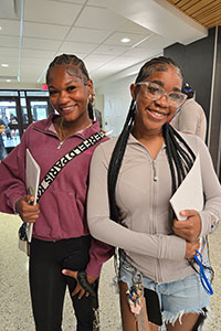 Two students at orientation, smiling for the camera.