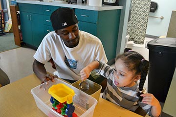 Early Childhood student working with a young child in the Integrated Preschool Laboratory.