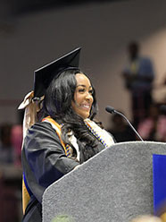 2026 graduation student speaker standing at the podium.