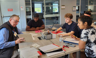 Tutor working with three students.