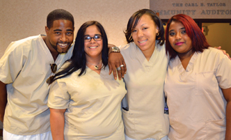 Group of adult students in scrubs.