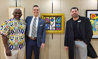 College administrators stand with community members who were guests of the college at a panel discussion on entrepreneurship.