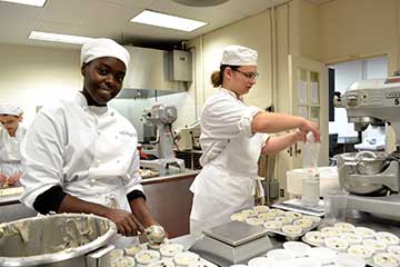 Students in a baking lab, making muffins.