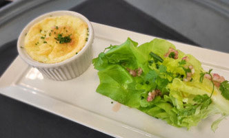 Example of an appetizer at Casola Dining Room, a cheese souffle served with butter bib lettuce salad.