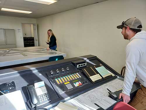 Student in the air traffic control classroom, working over a model of the Schenectady County Airport.