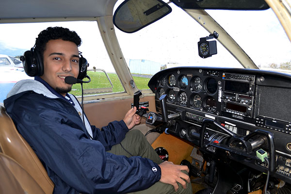 Aviation pilot option student in the cockpit of a small airplane.