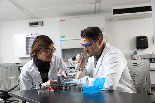 Faculty and student working in biotech lab.