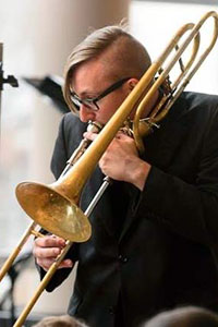 Chris Paul playing a trombone.