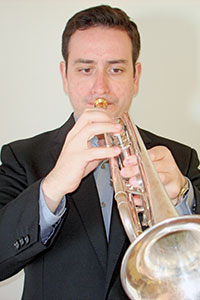 Headshot of Nikola Tomic playing a trumpet