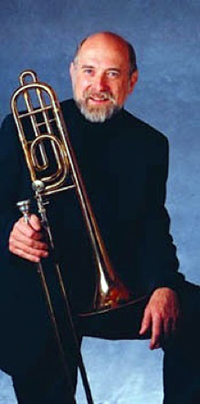 Headshot of Ronald Barron holding a trombone.