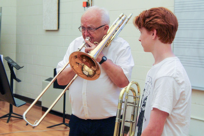 Trombone camp faculty member, Phil Brink, working with a single student.