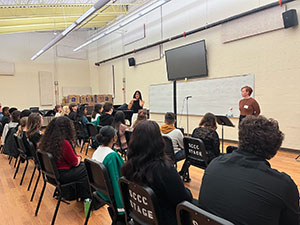 Faculty members work with a classroom of students on singing techniques.