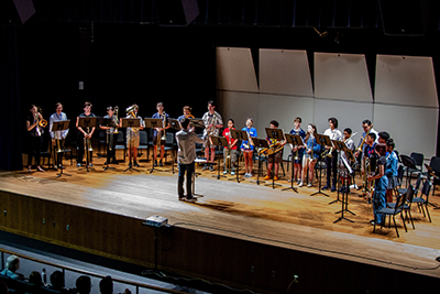 Students from the 2025 Trombone Institute on stage with their instructor.