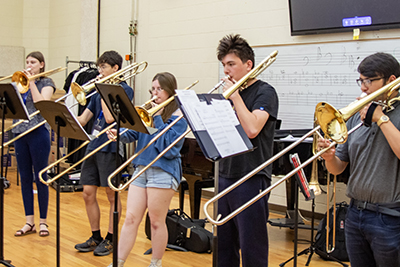 Group of Trombone Institute students in 2025, rehearsing together.