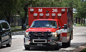 An ambulance driving down a road.