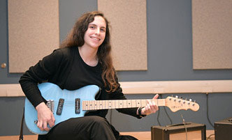 Woman playing an electric guitar.