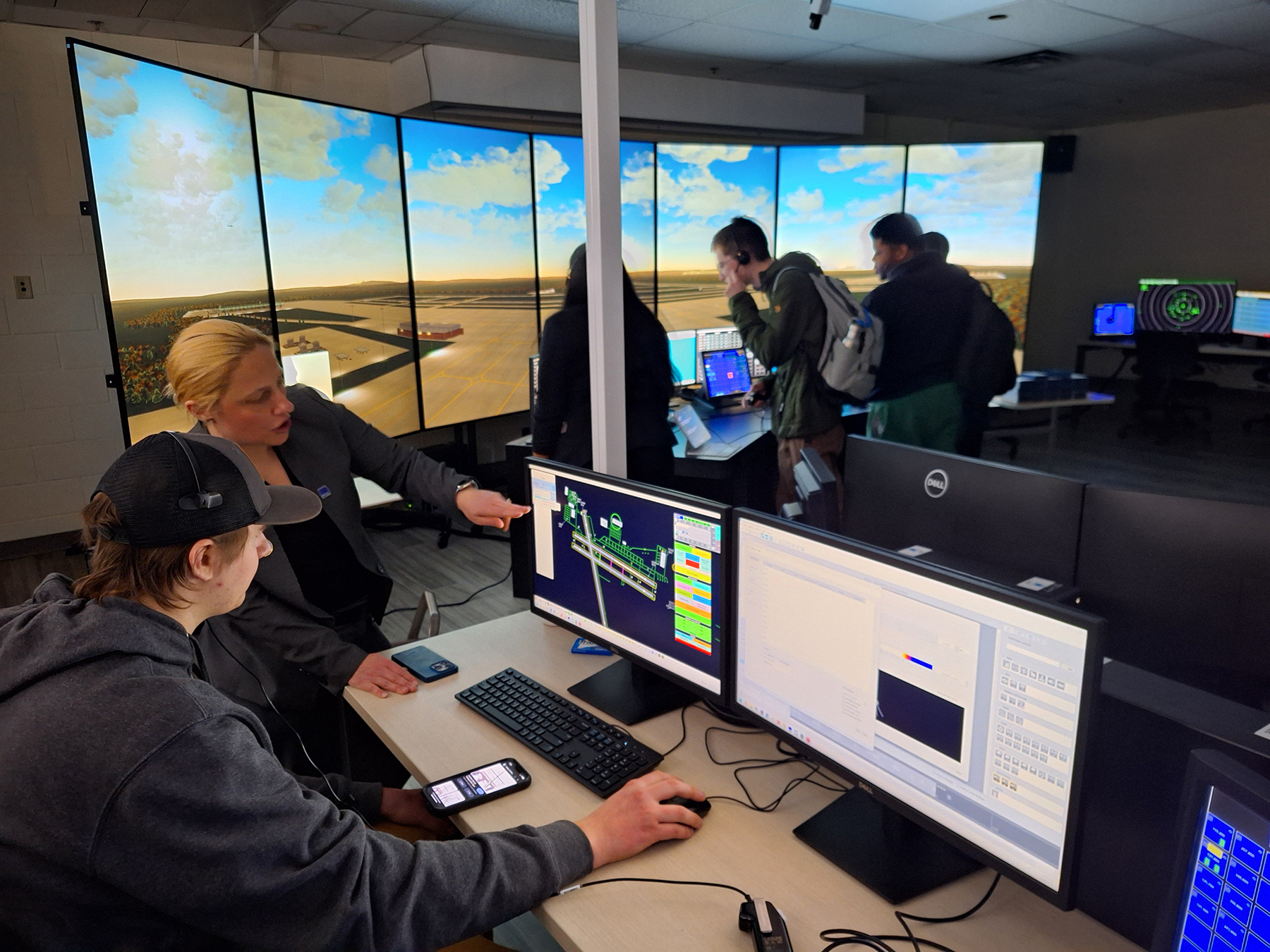 Amy Parish showing student how to use the new Air Traffic Control simulator