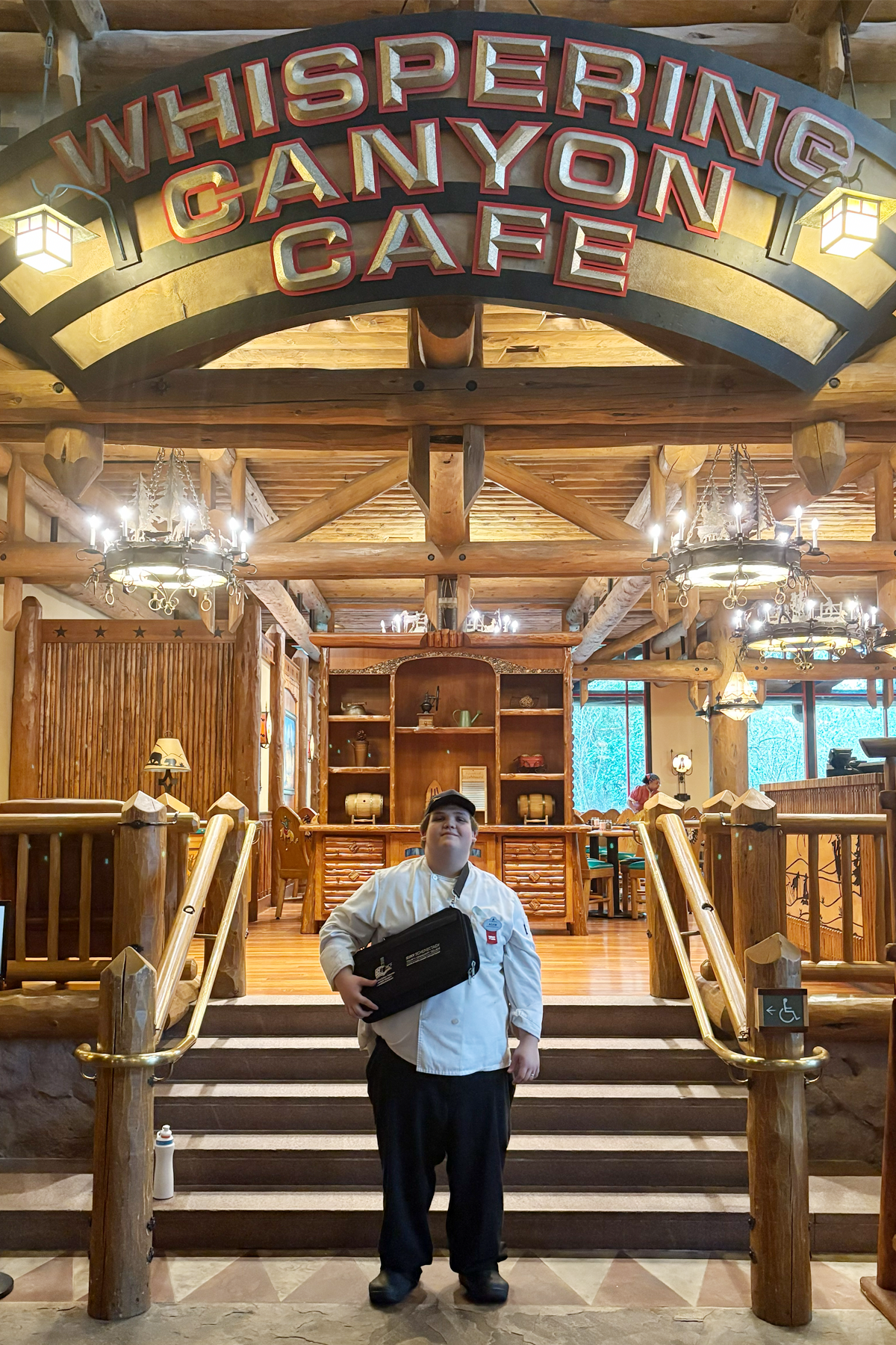 Adam Toucette in chef's uniform, standig in front of  Whispering Canyon Café, Disney World