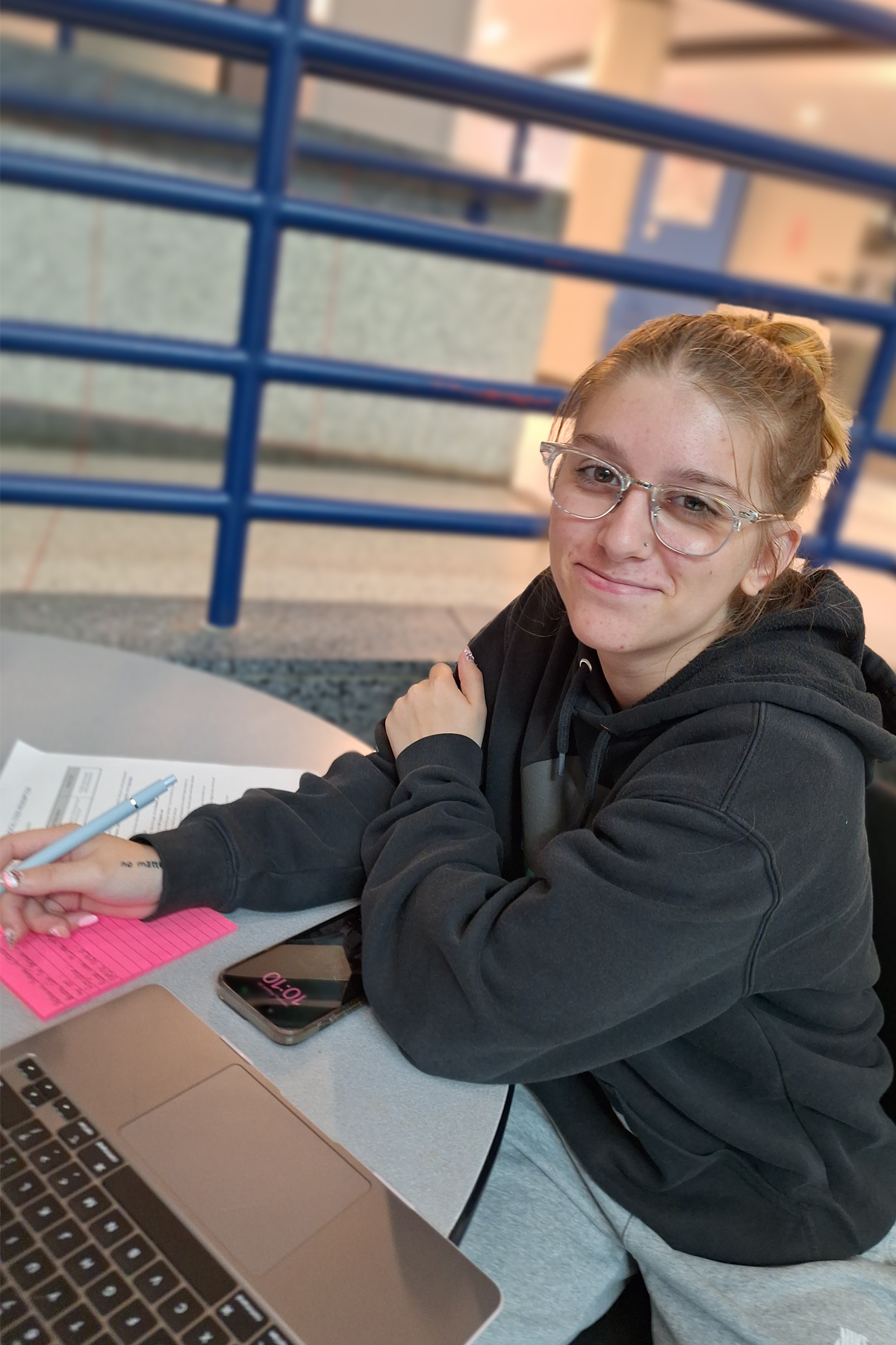 Alanah Donnelly sitting in cafeteria, smiling