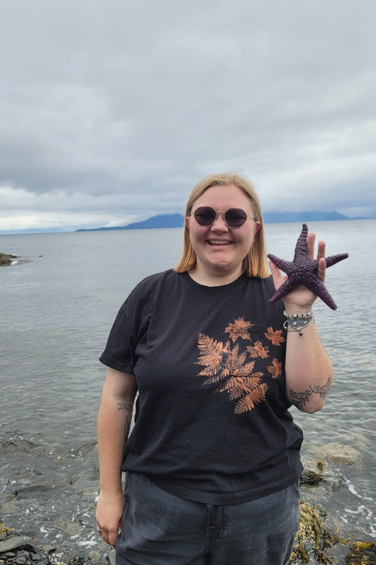Ally Becker holding starfish near water