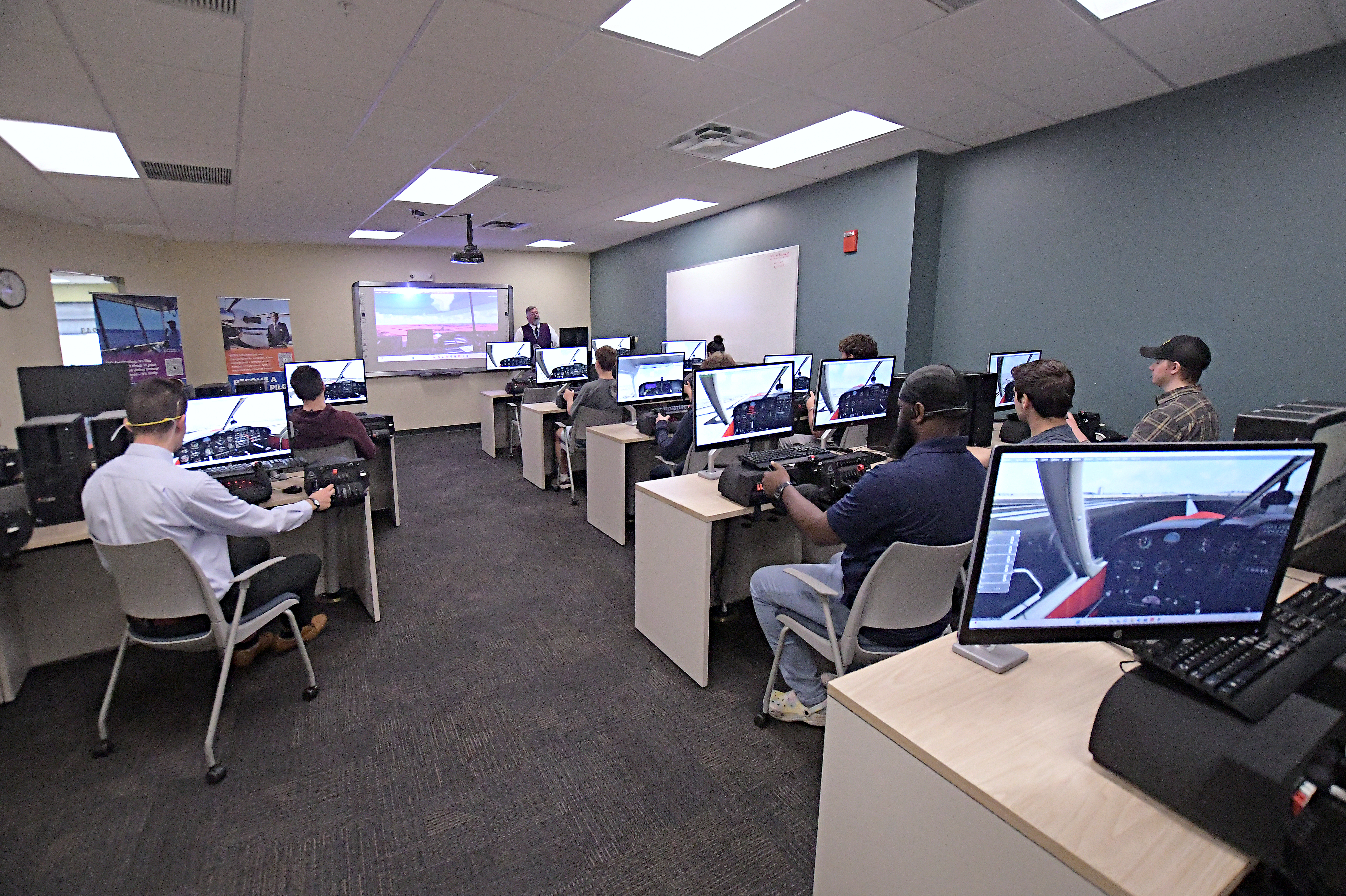 Students in STEM Aviation Lab using flight simulators