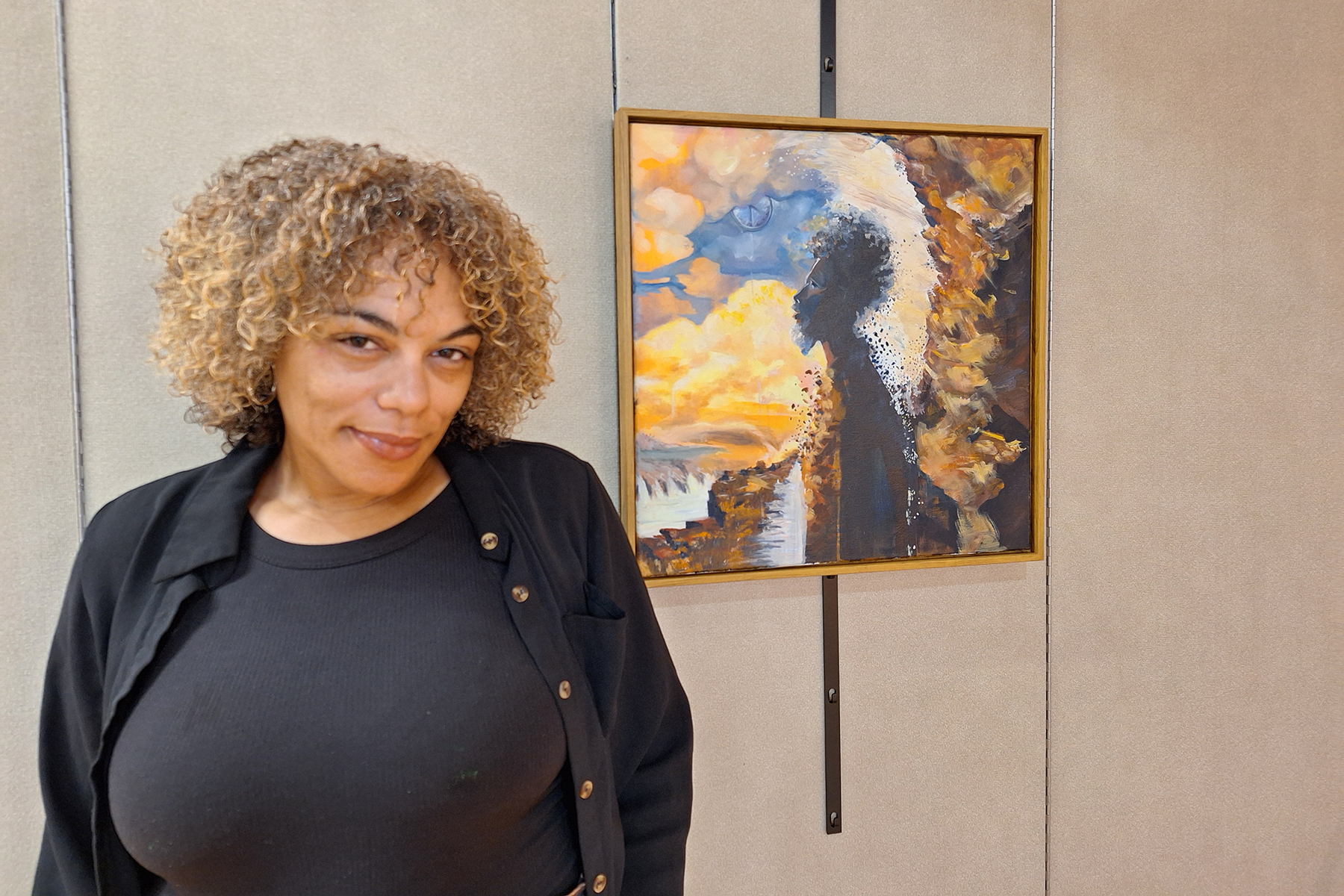 B.A. DiLella standing in front of her artwork