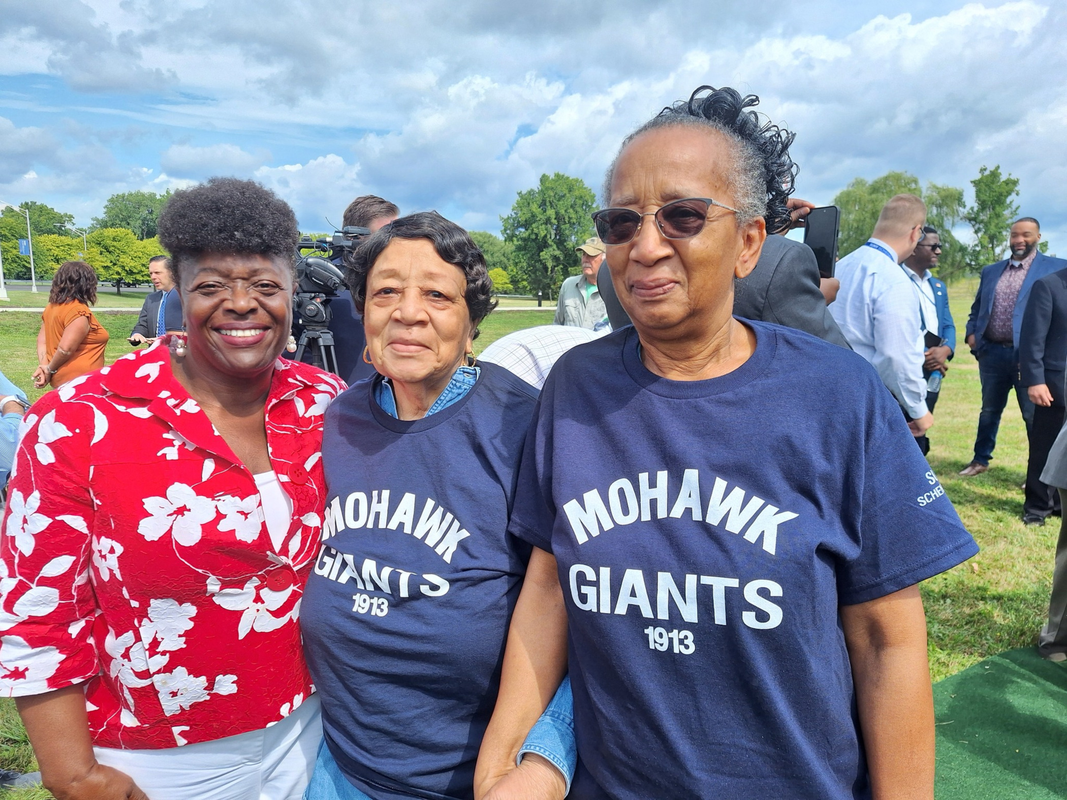 Three audience members wearing "Mohawk Giants" tshirts
