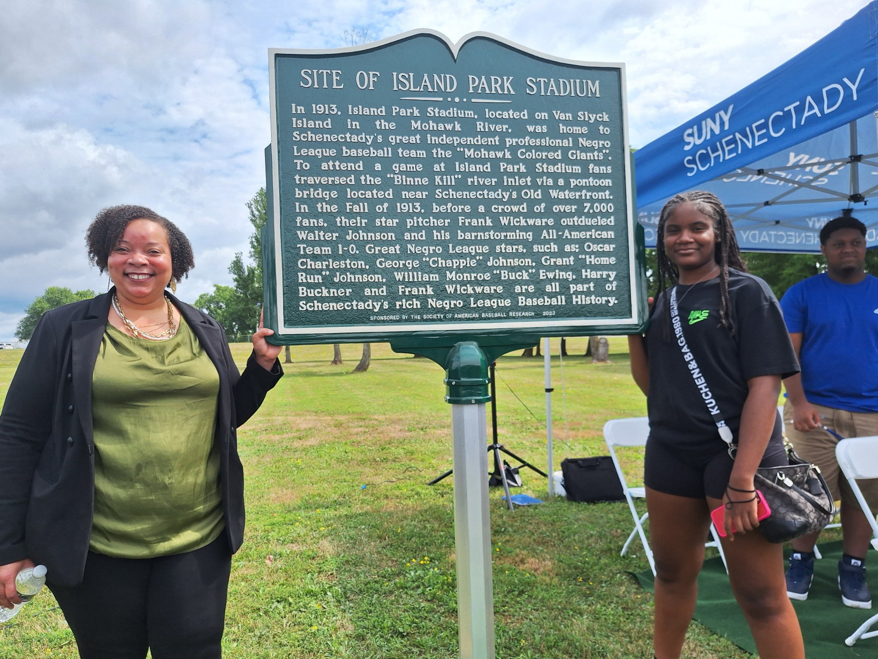 Tiombe Tatum and friend standing in front of historical marker
