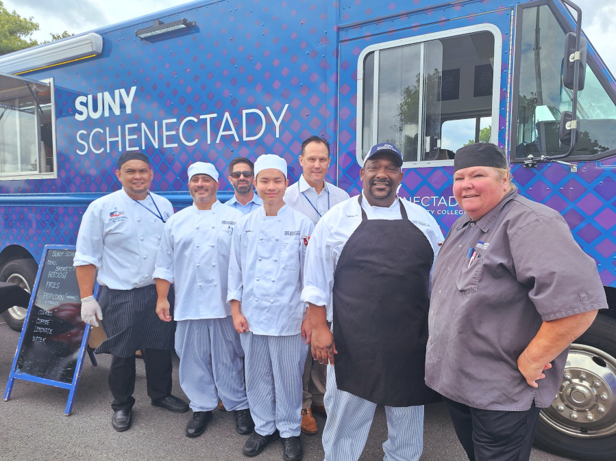 Students and faculty chefs in front of the Food Truck