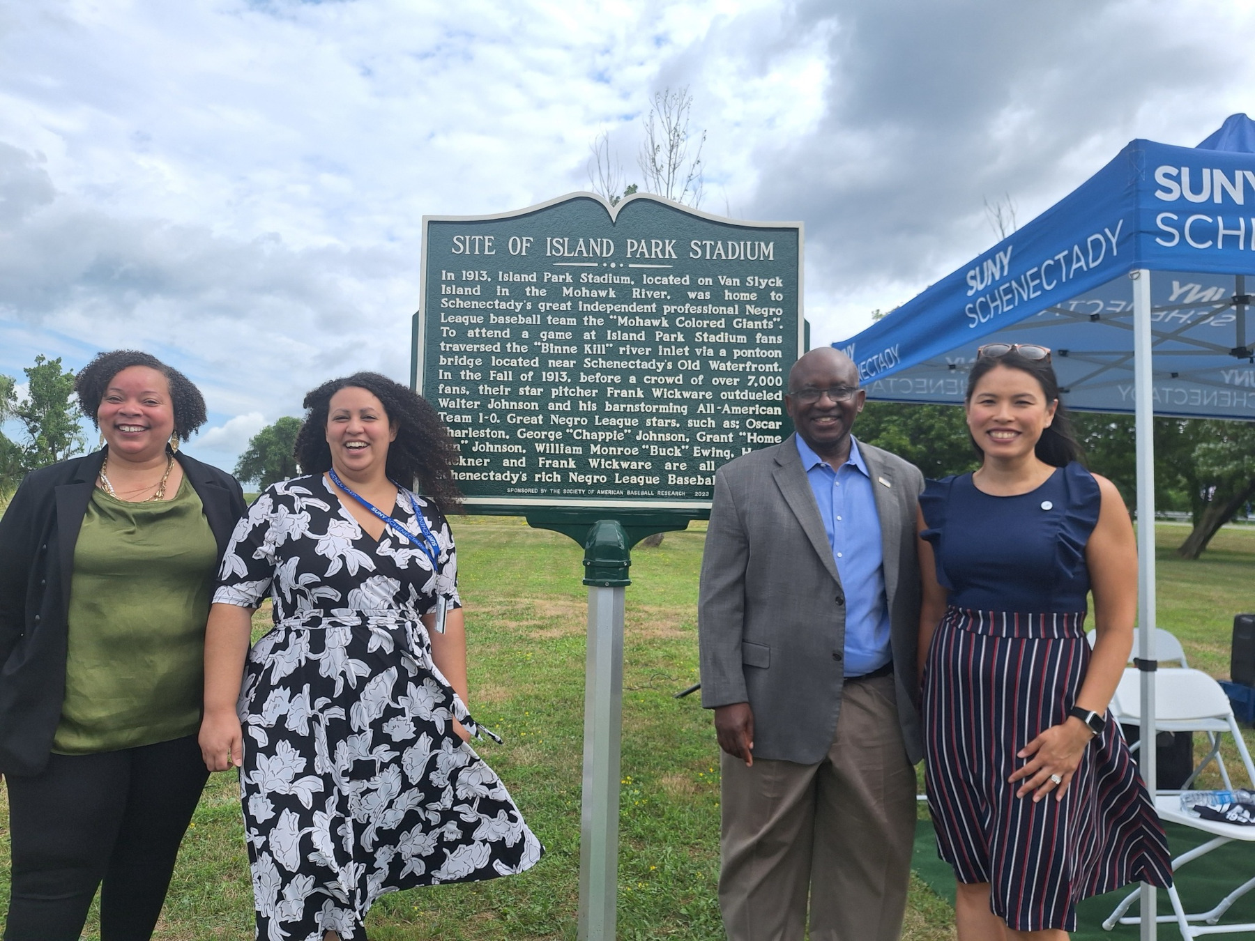 Dr. Moono and College officials standing near historical marker