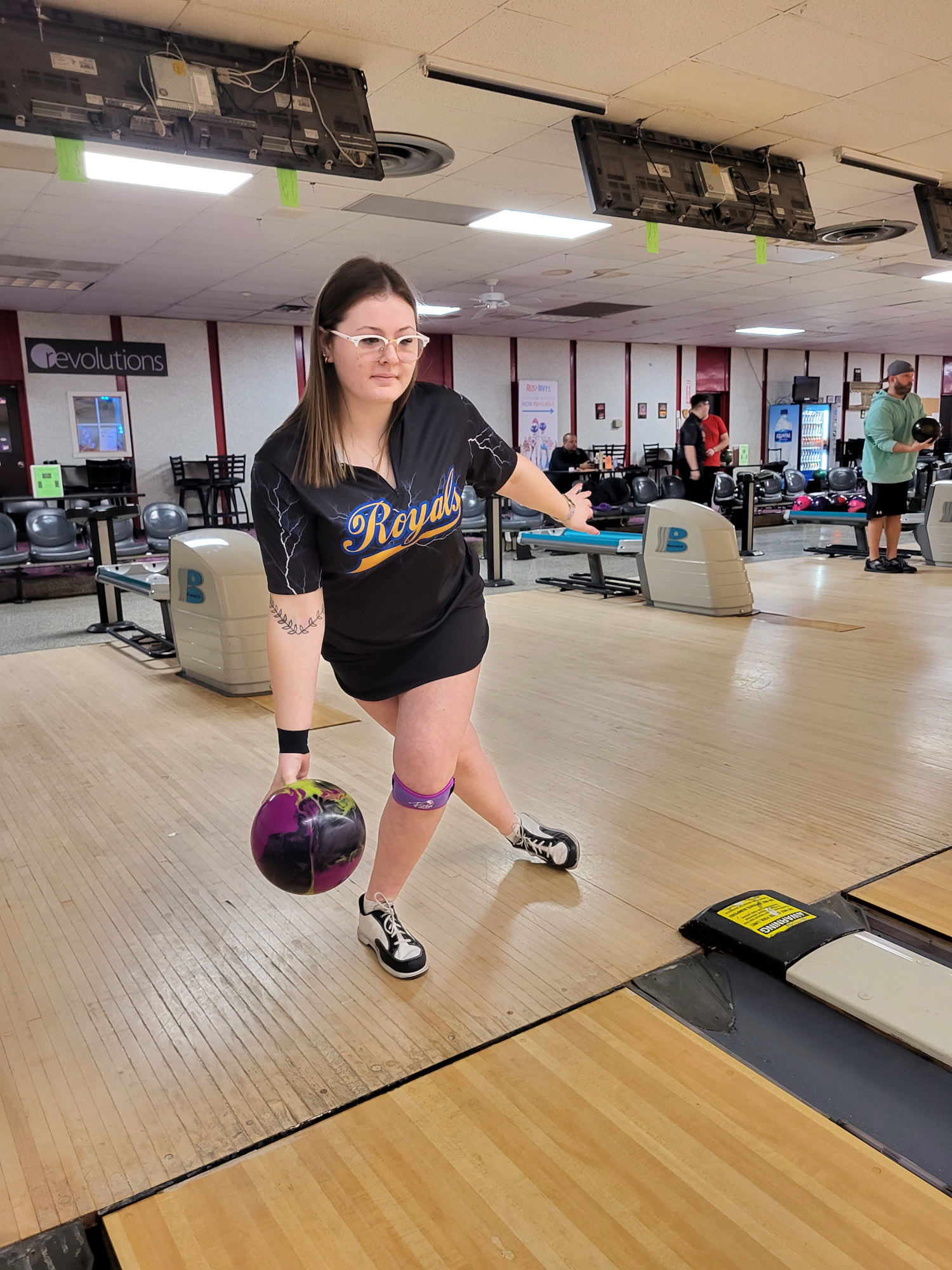 Eliza Arasim smiling, standing in Boulevard Bowl