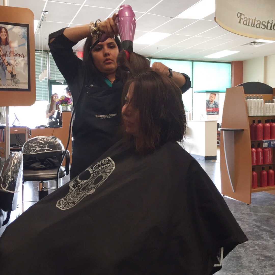 Brenda Beauregard cutting hair during her job as a hair stylist.