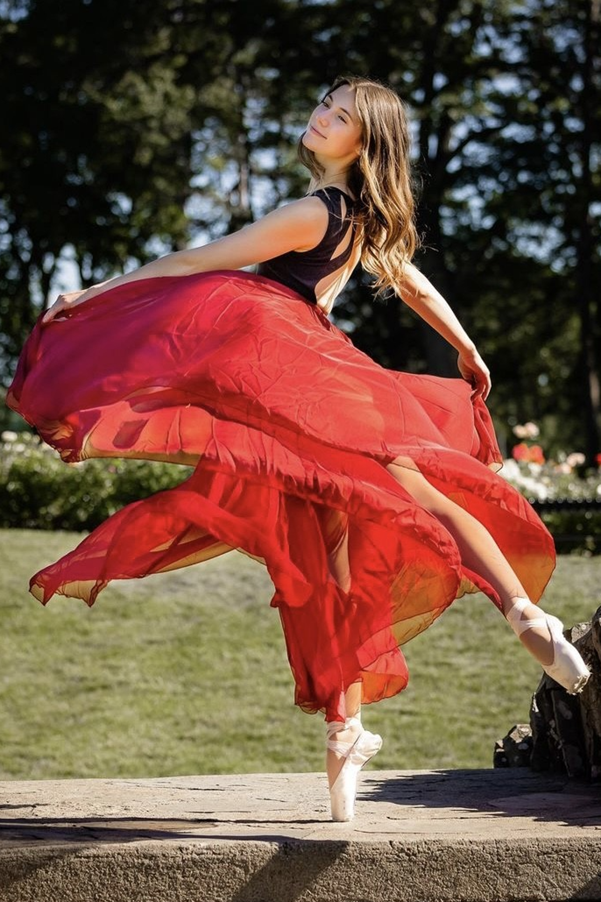 Caley Lacey, in red dress, dancing