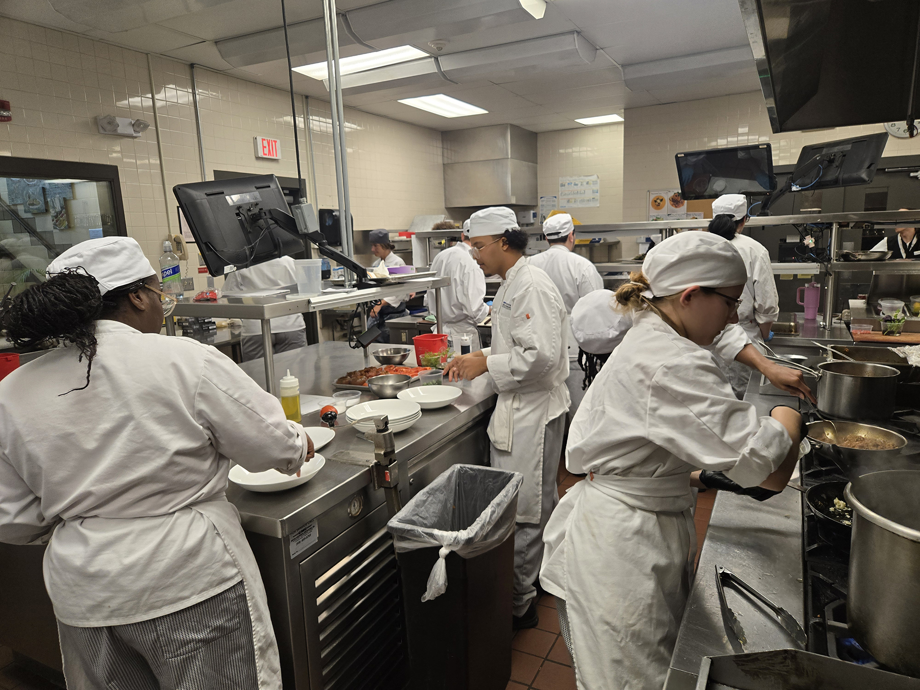 Student chefs cooking in kitchen