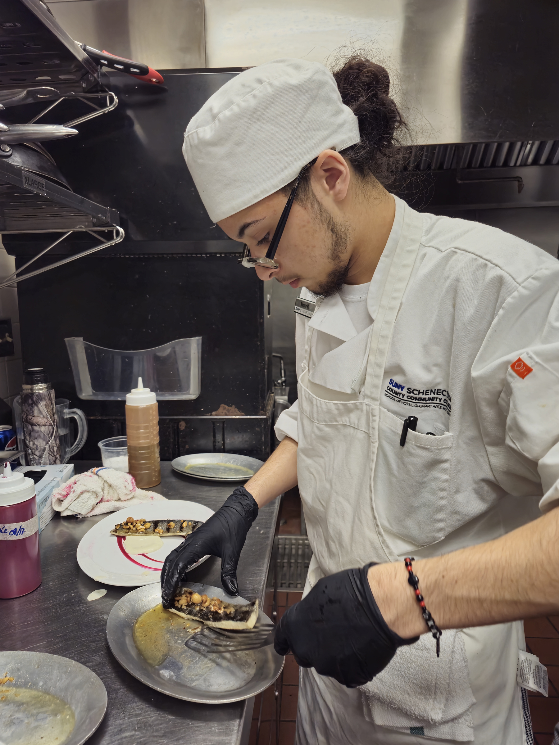 Student chef cooking in kitchen