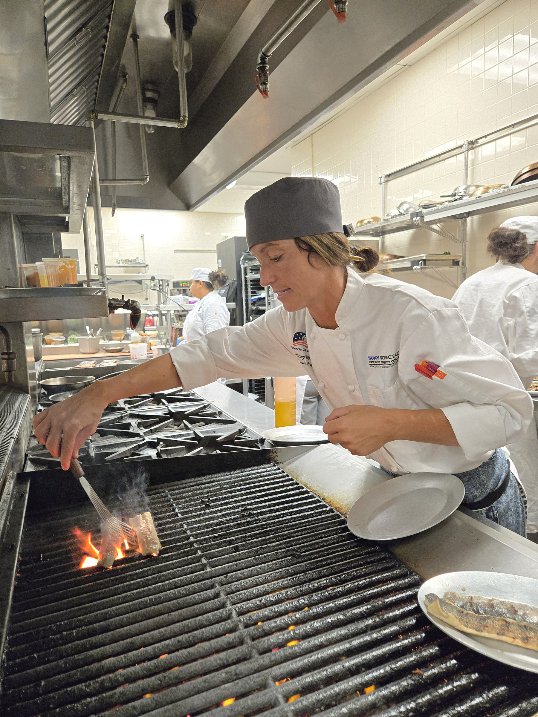 Chef Courtney Withey cooking in kitchen