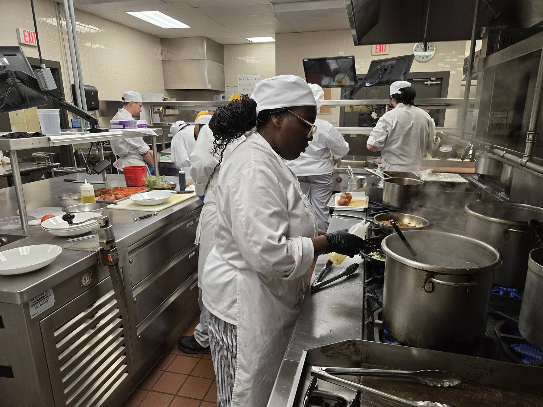 Student cooking in kitchen