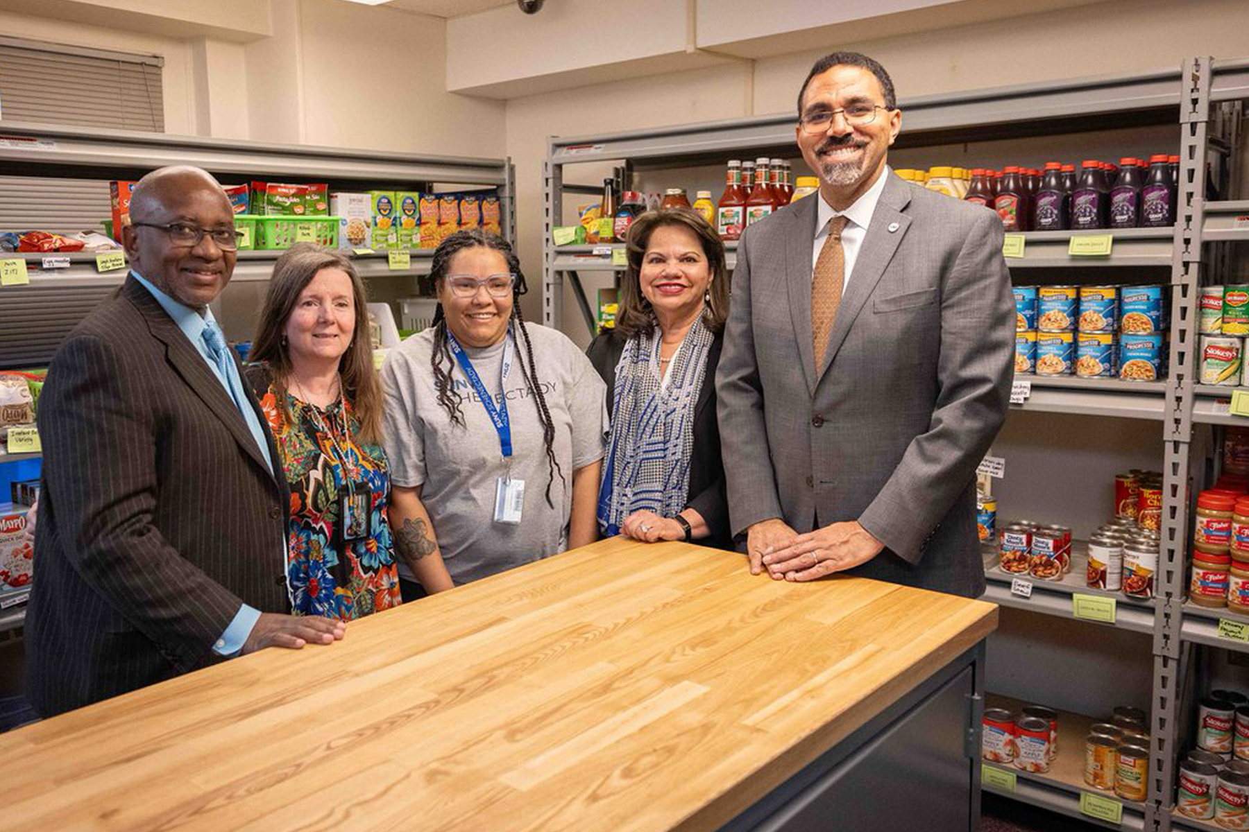 Chancellor King with President Moono, staff and students in Food Pantry