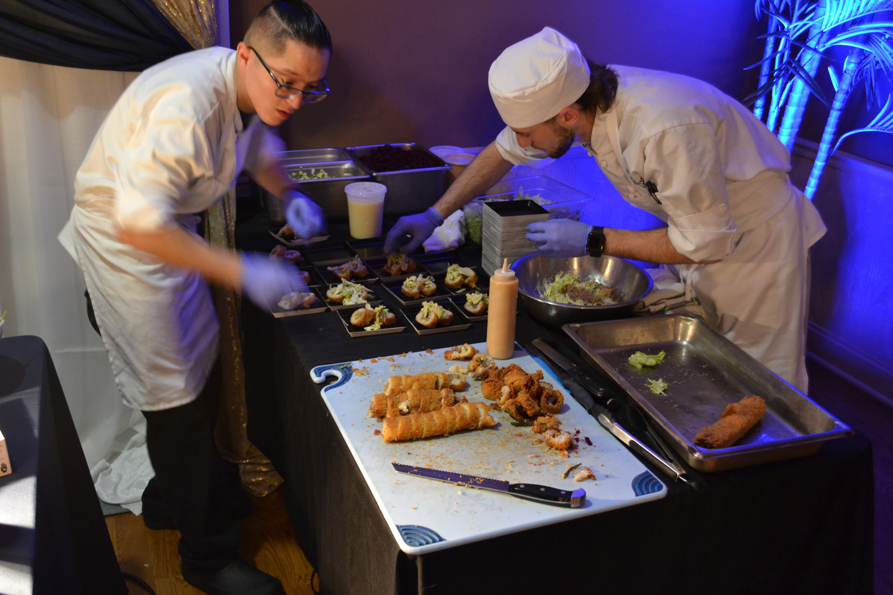 Guest Chef Cody Nguyen and Culinary Arts major Michael Keenan preparing cuisine