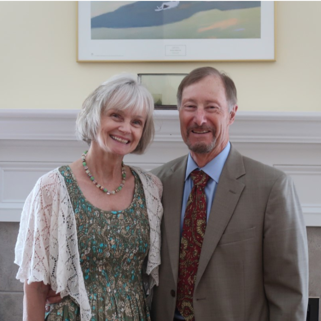 Chris and Laurie Coccio standing in front of mantle