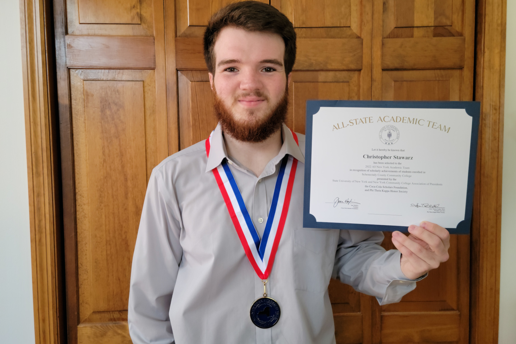 Christopher Stawarz holding All-New York Team certificate