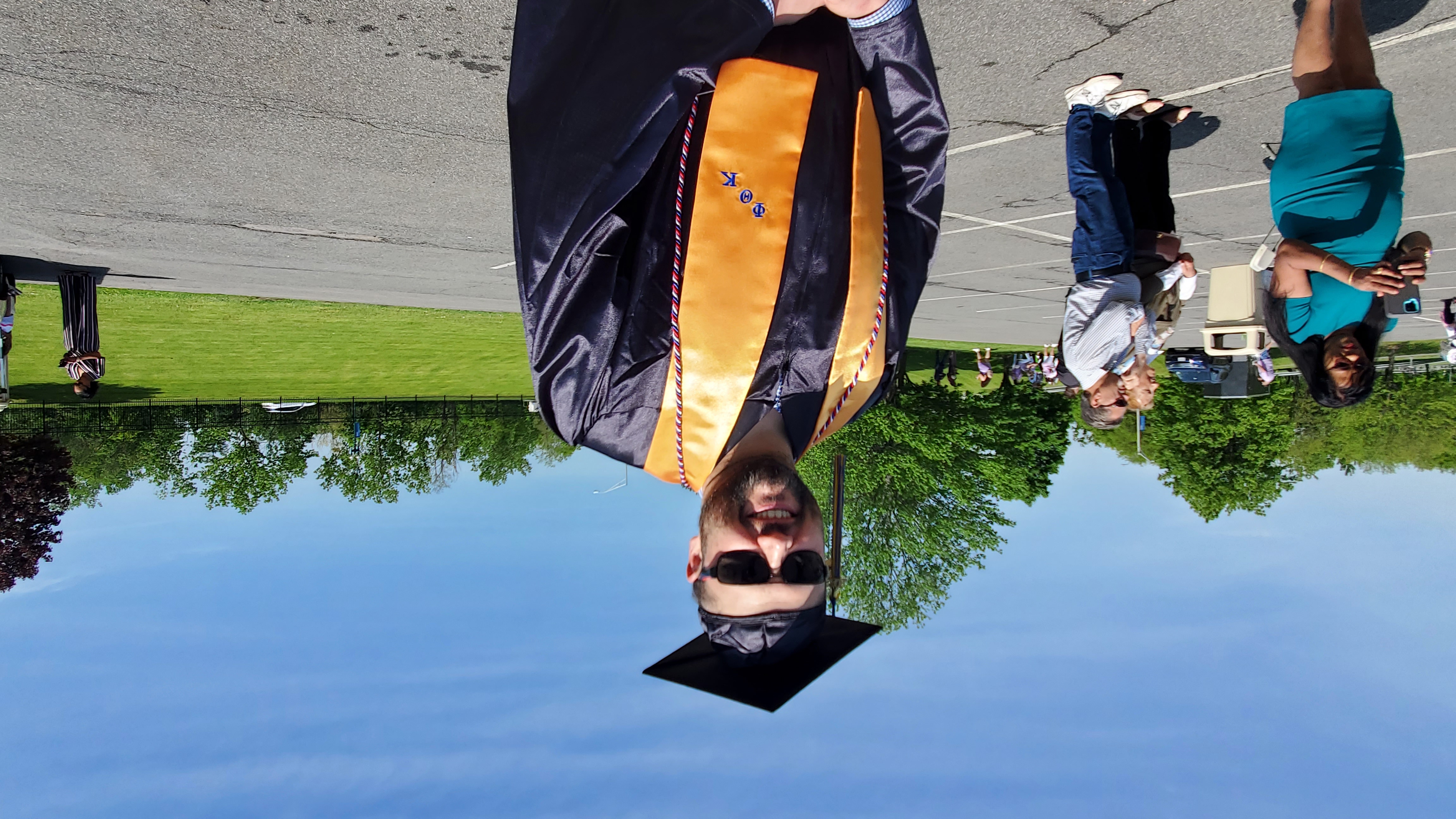 Male graduate standing outside waiting to go on stage