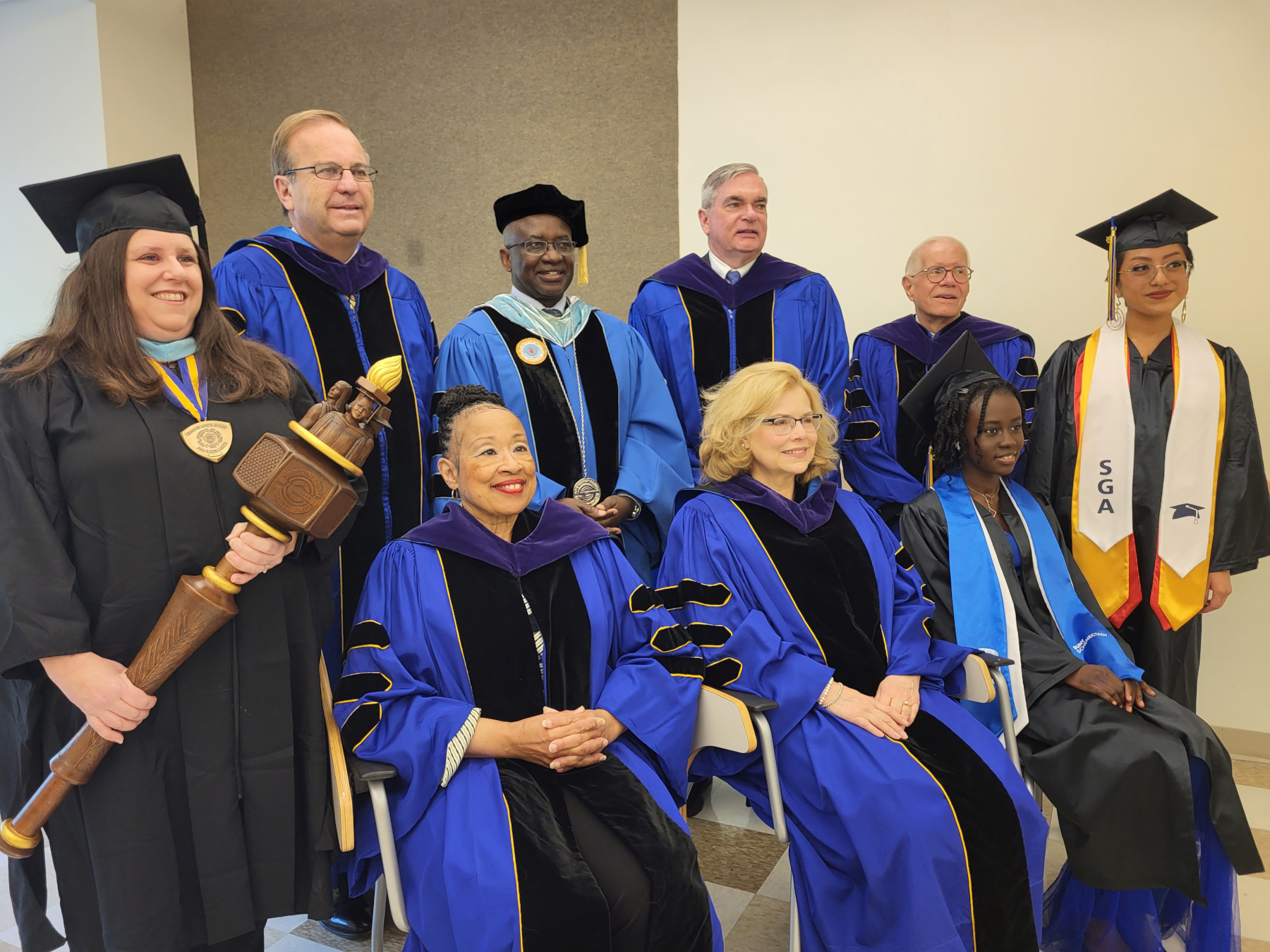 Trustees and College officials inside School of Music, posing for photo